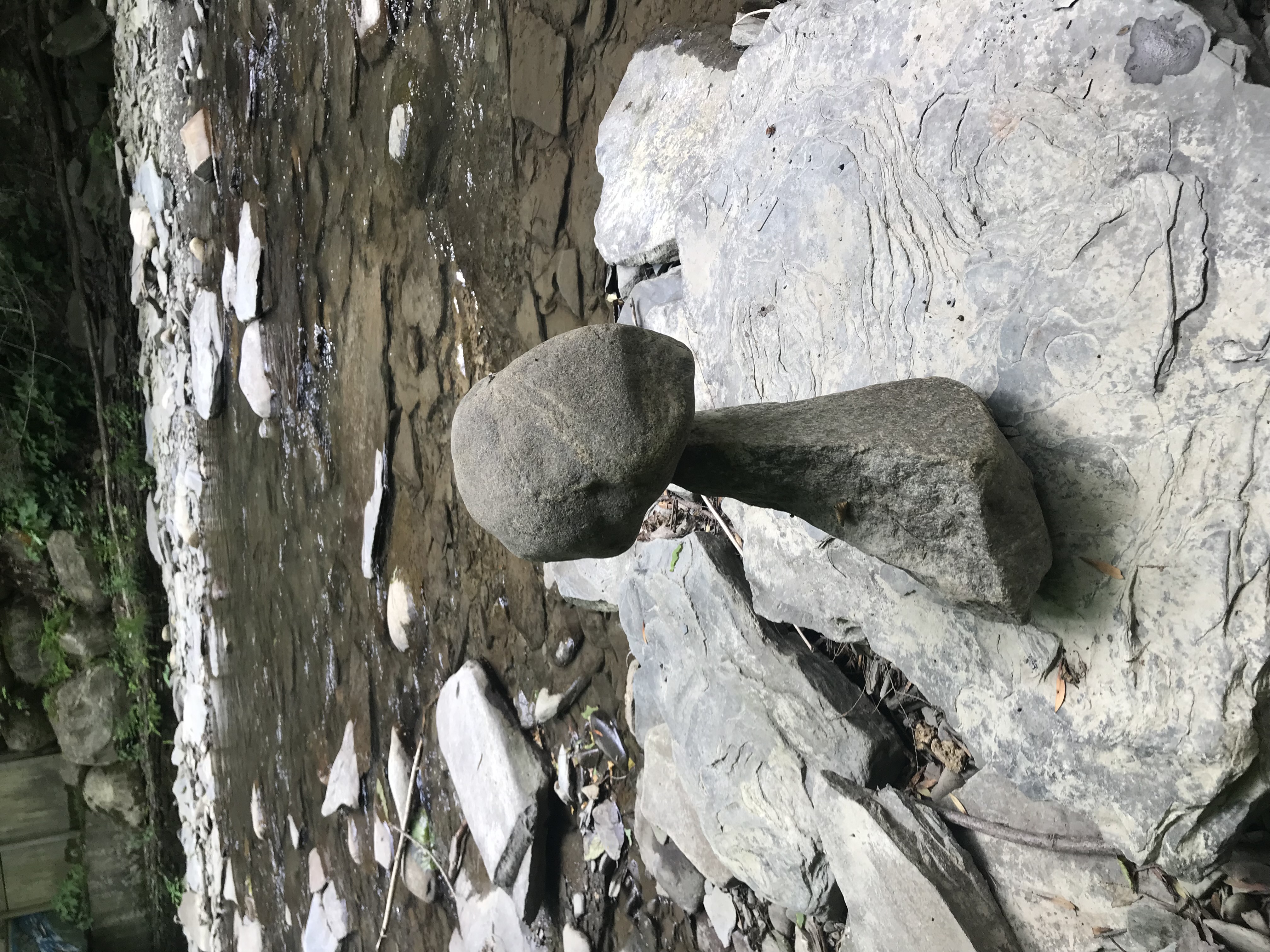 Two balanced stones by a rocky stream