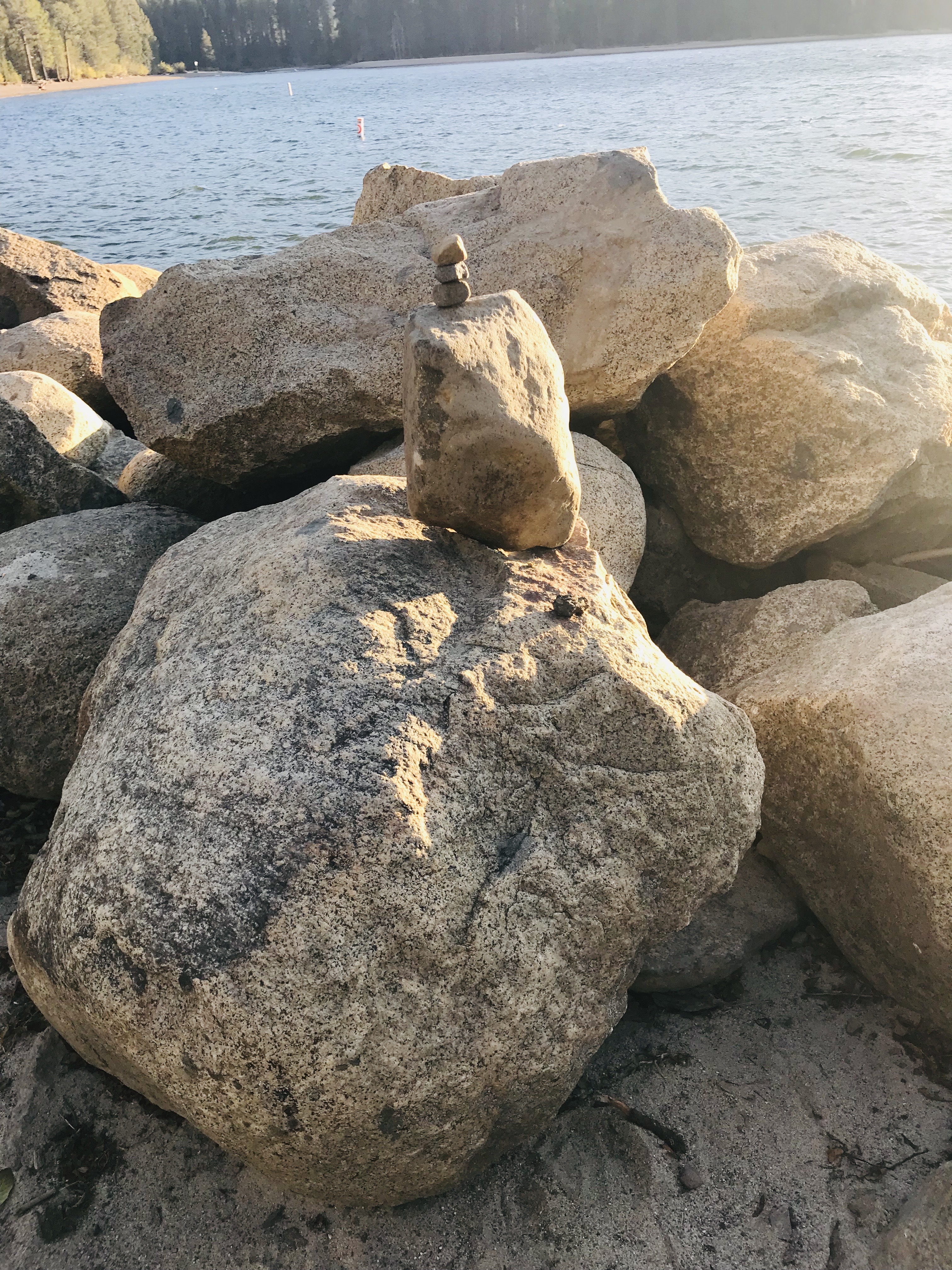 Small stone stack on lakeshore boulders